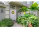 A welcoming front door with yellow wreath, complemented by lush landscaping and a colorful bicycle at 14116 Trouville Dr, Tampa, FL 33624