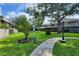 Well-maintained green space featuring mature trees and manicured landscaping perfect for outdoor enjoyment at 14116 Trouville Dr, Tampa, FL 33624