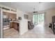 Open kitchen flows into the living area, featuring tile flooring and ample natural light at 14116 Trouville Dr, Tampa, FL 33624