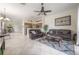 Open-concept living and kitchen area with tile floors and lots of natural light from the glass doors at 14116 Trouville Dr, Tampa, FL 33624