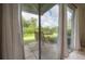 View from inside looking out to the backyard from the sliding glass doors on the patio at 14116 Trouville Dr, Tampa, FL 33624