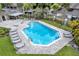 An outdoor community pool with brick pavers and lounge chairs at 14116 Trouville Dr, Tampa, FL 33624