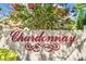 Close up of the Chardonnay neighborhood sign with blooming bougainvillea at 14116 Trouville Dr, Tampa, FL 33624