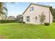 Backyard with green grass, lush shrubbery, a patio, and a view of the rear of the home at 16104 Bridgedale Dr, Lithia, FL 33547
