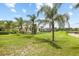 Spacious backyard with well-maintained lawn, fenced perimeter, and picturesque views of the adjacent lake at 16104 Bridgedale Dr, Lithia, FL 33547