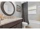 Bathroom featuring granite countertop vanity, tile floors, and a shower-tub combo at 16104 Bridgedale Dr, Lithia, FL 33547