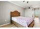 Comfortable bedroom features a ceiling fan, wood-look floors, crown moulding, and ensuite access at 16104 Bridgedale Dr, Lithia, FL 33547