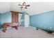 Attic bedroom with foosball table, a ceiling fan, a sliding barn door, and carpeting at 16104 Bridgedale Dr, Lithia, FL 33547