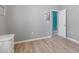 Cozy bedroom with neutral walls, wood-look flooring, and ensuite access at 16104 Bridgedale Dr, Lithia, FL 33547