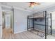 Charming bedroom with a bunk bed, built-in shelving, and a playful rug at 16104 Bridgedale Dr, Lithia, FL 33547
