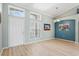 Dining room features wood floors and a window next to the front door at 16104 Bridgedale Dr, Lithia, FL 33547