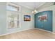 Bright dining area with wood floors, large windows, and elegant lighting at 16104 Bridgedale Dr, Lithia, FL 33547