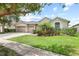 Beautiful single-story home showcasing lush landscaping and a three-car garage at 16104 Bridgedale Dr, Lithia, FL 33547