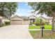 Charming home featuring a three-car garage, well-manicured landscaping, and inviting front entrance at 16104 Bridgedale Dr, Lithia, FL 33547
