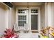 Close-up of front porch featuring two chairs and decorative plants by the door at 16104 Bridgedale Dr, Lithia, FL 33547