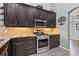 Gourmet kitchen featuring granite countertops, stainless steel appliances, and custom cabinets at 16104 Bridgedale Dr, Lithia, FL 33547