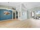 Bright living room featuring beautiful wood floors, arched entryways, and a sliding glass door at 16104 Bridgedale Dr, Lithia, FL 33547