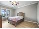Bedroom with wood floors and a sliding glass door to the screened patio at 16104 Bridgedale Dr, Lithia, FL 33547