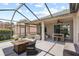 Outdoor patio with ceiling fans, comfortable seating, a dining table, and an outdoor firepit at 16104 Bridgedale Dr, Lithia, FL 33547