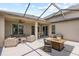Spacious covered patio features comfortable wicker seating, a dining table, and an outdoor firepit at 16104 Bridgedale Dr, Lithia, FL 33547