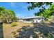 Large backyard with lush landscaping and a screened-in patio, perfect for outdoor activities at 1732 63Rd N Ave, St Petersburg, FL 33702