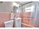 Charming pink bathroom with a shower-tub combo and a vintage vanity at 1732 63Rd N Ave, St Petersburg, FL 33702