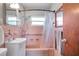 Updated pink-tiled bathroom featuring a shower and accessible grab bars at 1732 63Rd N Ave, St Petersburg, FL 33702