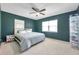 Comfortable bedroom with a ceiling fan, two windows, and closet space for shoe storage at 1732 63Rd N Ave, St Petersburg, FL 33702
