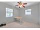 Simple bedroom featuring a ceiling fan, two windows, and a desk at 1732 63Rd N Ave, St Petersburg, FL 33702