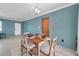 Dining room with a wooden table set for four under a modern chandelier at 1732 63Rd N Ave, St Petersburg, FL 33702
