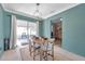 Well-lit dining area with a modern chandelier, table set for four, and access to the porch at 1732 63Rd N Ave, St Petersburg, FL 33702