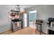 Cozy kitchen featuring stainless steel appliances, hanging pot rack, and doorway to the dining area at 1732 63Rd N Ave, St Petersburg, FL 33702