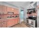 Kitchen features retro pink cabinets, stainless steel appliances, and ample counter space at 1732 63Rd N Ave, St Petersburg, FL 33702