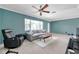 Bright living room boasts a ceiling fan, accent wall, and comfortable gray couch at 1732 63Rd N Ave, St Petersburg, FL 33702