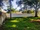Grass backyard with tall wood privacy fence at 1841 Georgia Ave, Palm Harbor, FL 34683