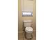 Simple bathroom showcasing a toilet under a window with blinds at 1841 Georgia Ave, Palm Harbor, FL 34683