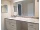 Bathroom featuring a granite countertop, vanity with storage, and a large mirror at 1841 Georgia Ave, Palm Harbor, FL 34683