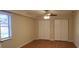 Bedroom with a ceiling fan, window and large closets at 1841 Georgia Ave, Palm Harbor, FL 34683