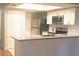 Modern kitchen with stainless steel appliances, a breakfast bar, and white cabinets at 1841 Georgia Ave, Palm Harbor, FL 34683
