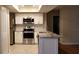 Bright kitchen featuring stainless steel appliances, granite countertops, and white cabinetry at 1841 Georgia Ave, Palm Harbor, FL 34683