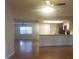 Open-concept view of the kitchen and living area featuring hardwood floors and ample natural light at 1841 Georgia Ave, Palm Harbor, FL 34683