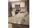 Bright kitchen featuring stainless steel appliances, granite countertops, and white cabinetry at 1841 Georgia Ave, Palm Harbor, FL 34683