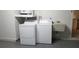 Functional laundry room with washer, dryer, and utility sink at 1841 Georgia Ave, Palm Harbor, FL 34683