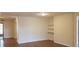 Inviting living room featuring hardwood floors, neutral walls, and built-in shelves at 1841 Georgia Ave, Palm Harbor, FL 34683