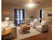 Virtual staging of a well-lit living room with elegant furniture and a stylish rug at 1841 Georgia Ave, Palm Harbor, FL 34683