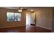 Bright living room with hardwood floors, a ceiling fan, and a large window at 1841 Georgia Ave, Palm Harbor, FL 34683