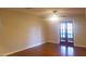 Bright living room featuring hardwood floors and double doors to the backyard at 1841 Georgia Ave, Palm Harbor, FL 34683