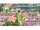 An aerial view of the community showing lush landscaping, tile roofs and ample common green space at 19029 Us Highway 19 N # 5-14, Clearwater, FL 33764