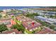 An aerial view of the community showing lush landscaping, tile roofs and proximity to the ocean at 19029 Us Highway 19 N # 5-14, Clearwater, FL 33764