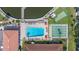 Aerial view of a sparkling blue pool, a putting green, and a shuffleboard court at 19029 Us Highway 19 N # 5-14, Clearwater, FL 33764
